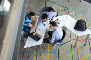 A team of network technicians carefully planning a network installation project in a business setting.