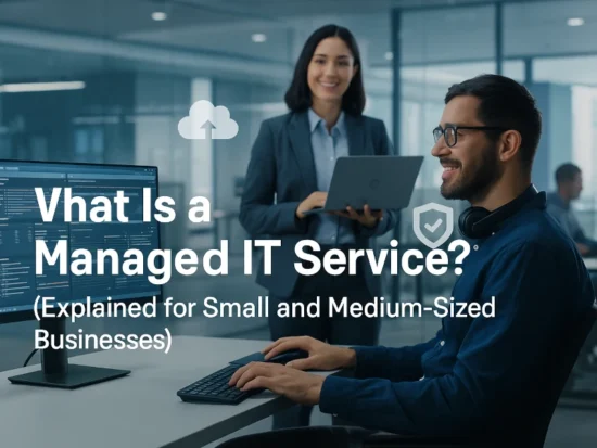 IT technician and business professional reviewing computers and cloud systems as part of managed IT services.