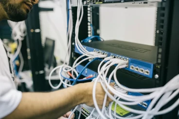 A Network Services technician installing a router.